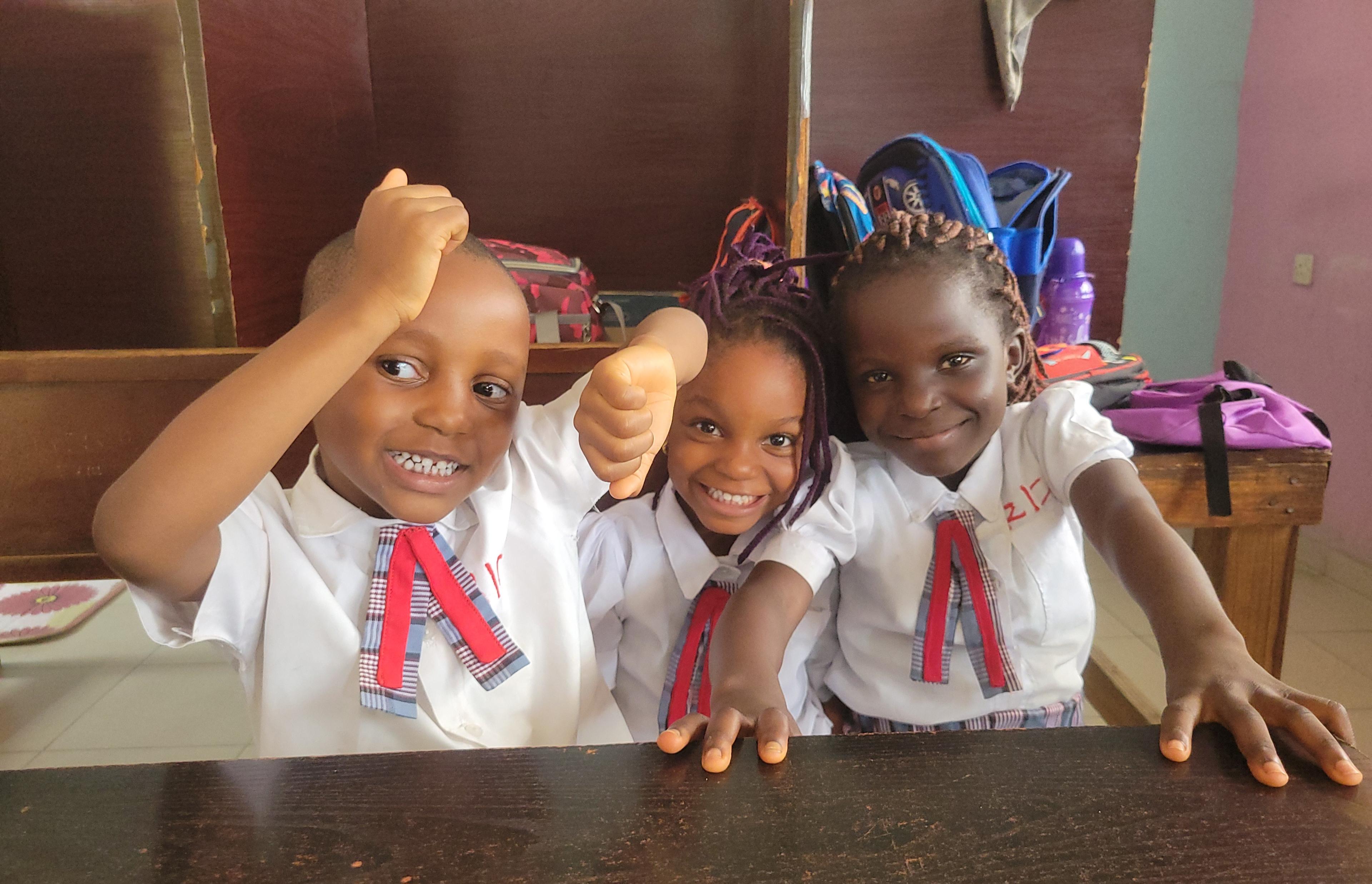 students sitted in a classroom smiling